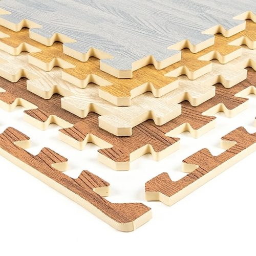 Stacked EVA foam wood-print interlocking tiles in multiple colours with matching edging pieces shown on a white background.