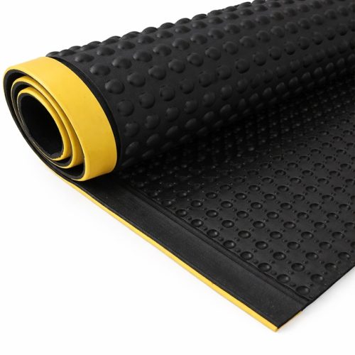 black anti-fatigue rubber mat with raised bubble surface and yellow beveled safety edge on a white background.